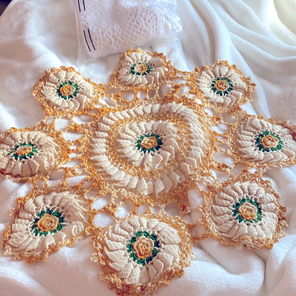 Crochet round 20 inches table topper. In cream variegated, oranges. And green.